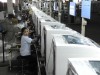 Employees assemble washing machines on the production line inside a factory of Hefei Rongshida Sanyo Electric in Hefei